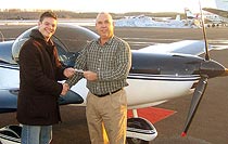 FAA Examiner Michael Price (right) hands Davin Coburn a Temporary Airman Certificate following my check ride. 